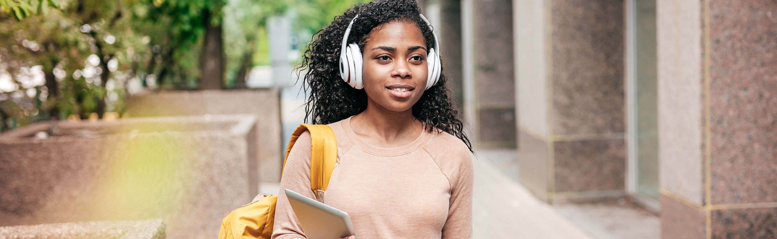 Student walking with headphones